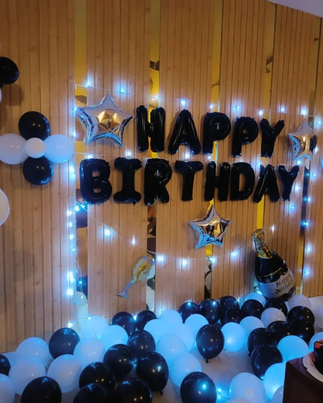 birthday decoration with black and white balloons